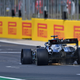 Lewis Hamilton crosses the line at Silverstone with a puncture.